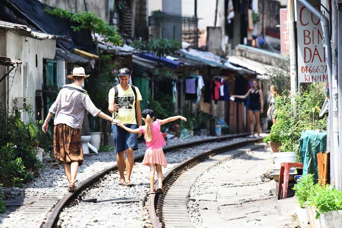 In central Hanoi, foreign tourists turn train track into outdoor studio