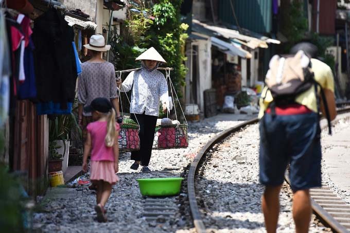 In central Hanoi, foreign tourists turn train track into outdoor studio