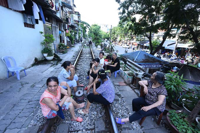 In central Hanoi, foreign tourists turn train track into outdoor studio